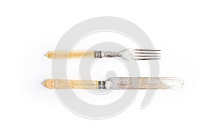 Set of vintage dinnerware. Knife and fork with bone handles on a white background. Top view.