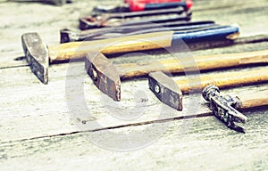 Set of vintage hand construction tools hammers on a wooden background, retro concept