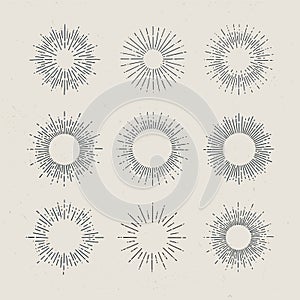 Set of vintage hand drawn sunbursts on dark background.