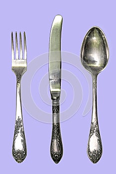 Set of vintage silver spoons and forks isolated on blue background