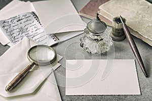 Set of vintage stationery, wooden pen, inkwell, magnifier and envelopes, letters close up. Writing a letter. Memory and