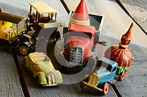 Set of vintage toys - convertible toy car, trucks (lorries) toy, post car toy and spinning (humming) tops