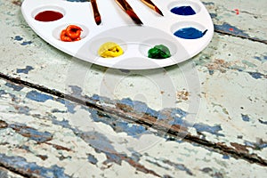 Set of watercolor aquarell rainbow paints and brushes on vintage
