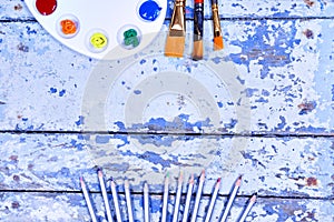 Set of watercolor aquarell rainbow paints and brushes on vintage photo
