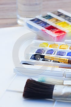 Set of watercolor paints with brushes