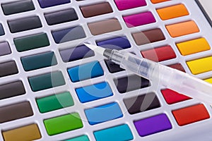 Set of watercolor paints, brushes for painting. Multicolors photo
