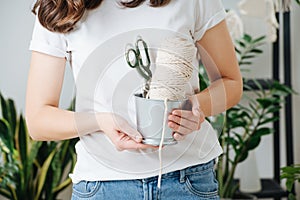 Set for weaving macrame, coil with rope and scissors in a bucket