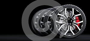 Set of wheels with modern alu rims on black background photo