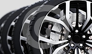 Set of wheels with modern alu rims close-up on white photo