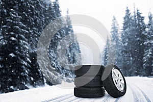 Set of wheels with winter tires outdoors on snowy road