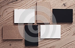 Set of white, black and craft business cards on wood table. Top view. Horizontal