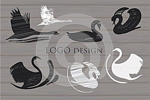 Set white and Black Swans Logo on wood background. Design templ