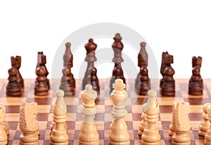 Set of white and black wooden chess pieces standing on a chessboard,  on white background