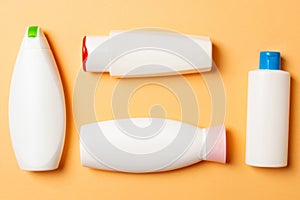 Set of White Cosmetic containers isolated on colored background, top view with copy space. Group of plastic bodycare