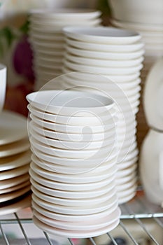 Set of white dishes on white.Stack of plates