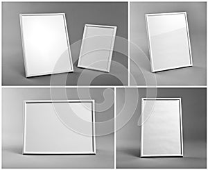 Set of white frames for paintings or photographs on gray background.