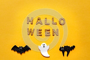 Set of white ghost, black cat and bat isolated on orange color background. Halloween ornament