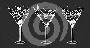 Set of white grunge drawings of refreshing cocktails with ice cubes, straws and umbrellas on a dark background