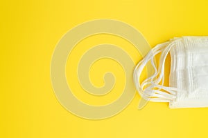 Set of white medical mask isolated on yellow background.