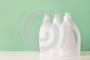 Set of white plastic bottles of liquid laundry detergent or cleaning agent or bleach or fabric softener