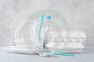 Set of white plastic disposable tableware and packaging