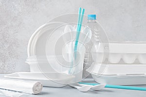 Set of white plastic disposable tableware and packaging