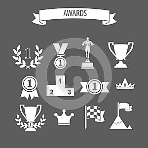 set of white vector award success and victory icons with trophies cups ribbons medals medallions wreath and a podium on grey