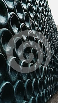 A set of wine bottles arranged in a winery photo