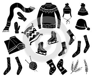Set of winter clothes, sweater, hat, scarf, skates, socks. Black silhouettes of outerwear isolated on white background.