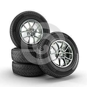 set of winter tyres stacked on a white background