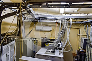 A set of wires and cables intertwined in datacenter server room. Top view of the control room