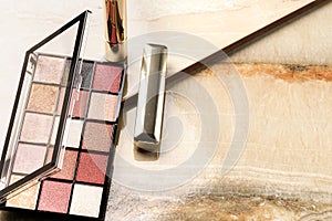 Set of woman make up cosmetics on stone background.