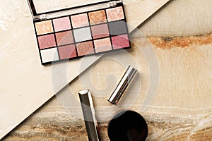 Set of woman make up cosmetics on stone background.