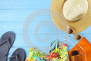 Set of woman`s colorful accessories to beach season swimsuit, sunglasses and hat top view, flat lay, copy space