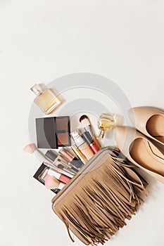 Set of woman`s cosmetics in a bag. Women`s secrets. Cosmetics, perfume, brushes, powder, highlighter, concealer,patelle with eye s