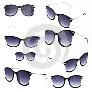 Set of women`s sunglasses with purple tint stand frontally isolated on a white background with a shadow.