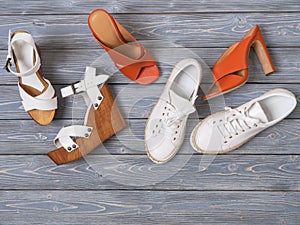 Set of womens shoes flat sandals on  wooden background. Spring summer collection. Flat lay. Fashion concept. Template for online