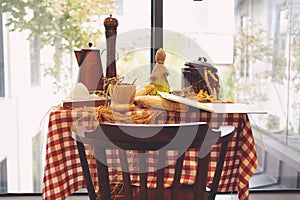 Set of wood and steel coffee table and chairs with white ceramic vase and colorful flowers outside of the coffee shop.