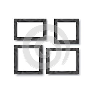 A set of wooden black frames for photos or pictures on the wall with a shadow.