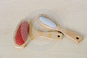 set of wooden combs with metal teeth of longitudinal and transverse combing, tools for hair of different thicknesses lie on light