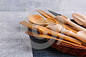 Set of wooden kitchen appliances, spoons, scoops, forks and knives. View from above.