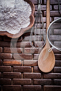 Set of wooden spoon bowl flower sieve and egg-whisk