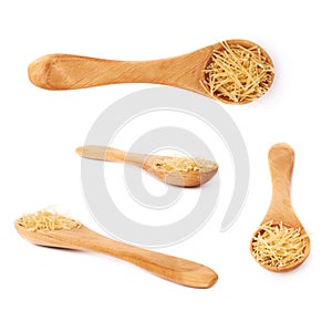 Set of wooden spoon filled with dry noodles pasta over isolated white background