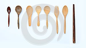 Set wooden spoon, fork and chopstick isolated over white background. Top view