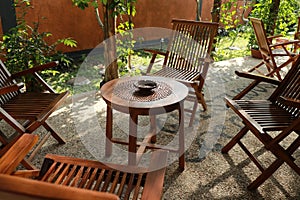 Set of wooden table and chairs in the garden. Teak wood furniture stand on the terrace