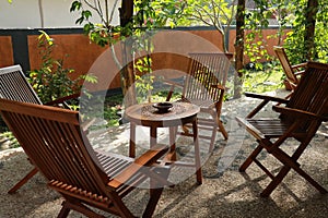 Set of wooden table and chairs in the garden. Teak wood furniture stand on the terrace