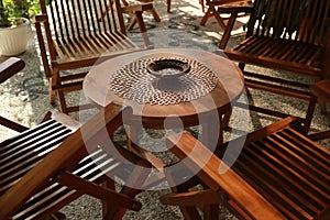 Set of wooden table and chairs in the garden. Teak wood furniture stand on the terrace