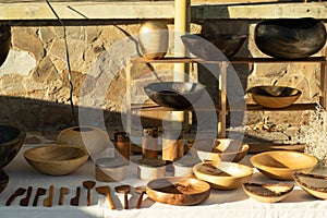 Set of wooden utensils on the table. Plates and cutlery. Wooden items