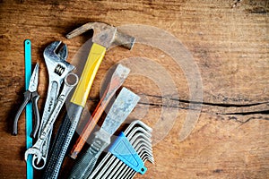 Set of work tools on old grunge wooden background