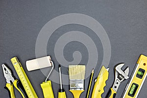 Set of working tools for construction or home repair works on dark grey background